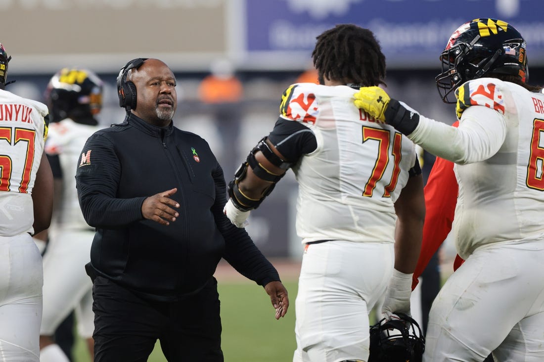 Dec 29, 2021; New York, NY, USA; Maryland Terrapins head coach Mike Locksley (left) talks with offensive lineman Jaelyn Duncan (71) during the second half of the 2021 Pinstripe Bowl against the Virginia Tech Hokies at Yankee Stadium. Mandatory Credit: Vincent Carchietta-USA TODAY Sports