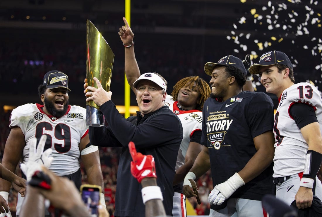 Jan 10, 2022; Indianapolis, IN, USA; Georgia Bulldogs head coach Kirby Smart celebrates with the championship trophy after defeating the Alabama Crimson Tide in the 2022 CFP college football national championship game at Lucas Oil Stadium. Mandatory Credit: Mark J. Rebilas-USA TODAY Sports