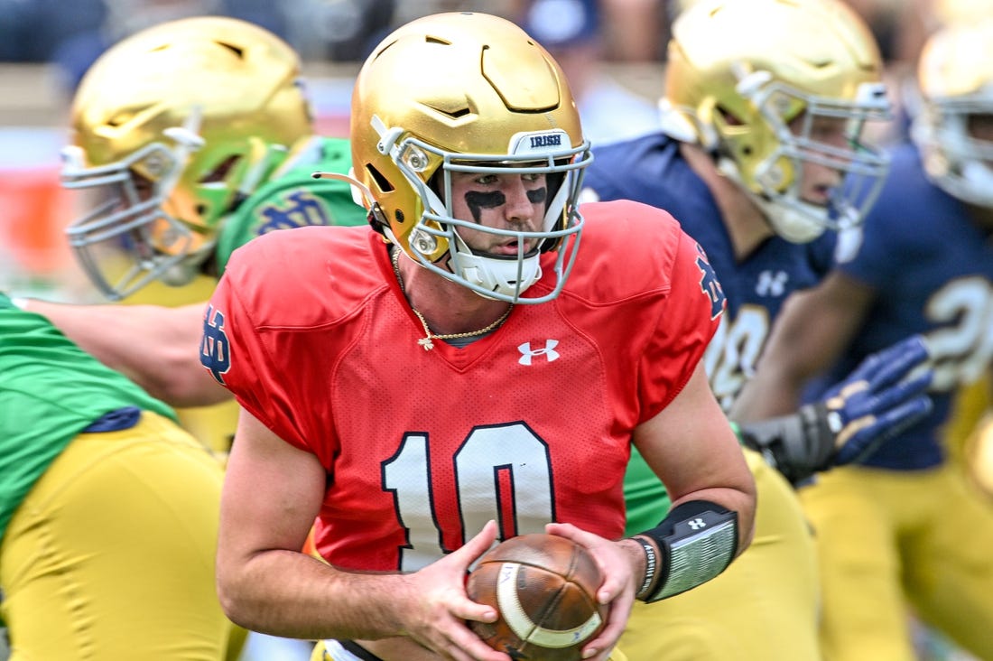 Apr 23, 2022; Notre Dame, Indiana, USA; Notre Dame Fighting Irish quarterback Drew Pyne (10) looks to hand off in the first quarter of the Blue-Gold Game at Notre Dame Stadium. Mandatory Credit: Matt Cashore-USA TODAY Sports