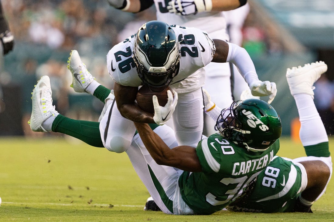 Aug 12, 2022; Philadelphia, Pennsylvania, USA; New York Jets cornerback Michael Carter II (30) tackles Philadelphia Eagles running back Miles Sanders (26) during the first quarter at Lincoln Financial Field. Mandatory Credit: Bill Streicher-USA TODAY Sports