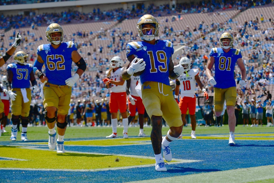 Sep 3, 2022; Pasadena, California, USA; UCLA Bruins wide receiver Kazmeir Allen (19) scores a touchdown against the Bowling Green Falcons during the first half at Rose Bowl. Mandatory Credit: Gary A. Vasquez-USA TODAY Sports