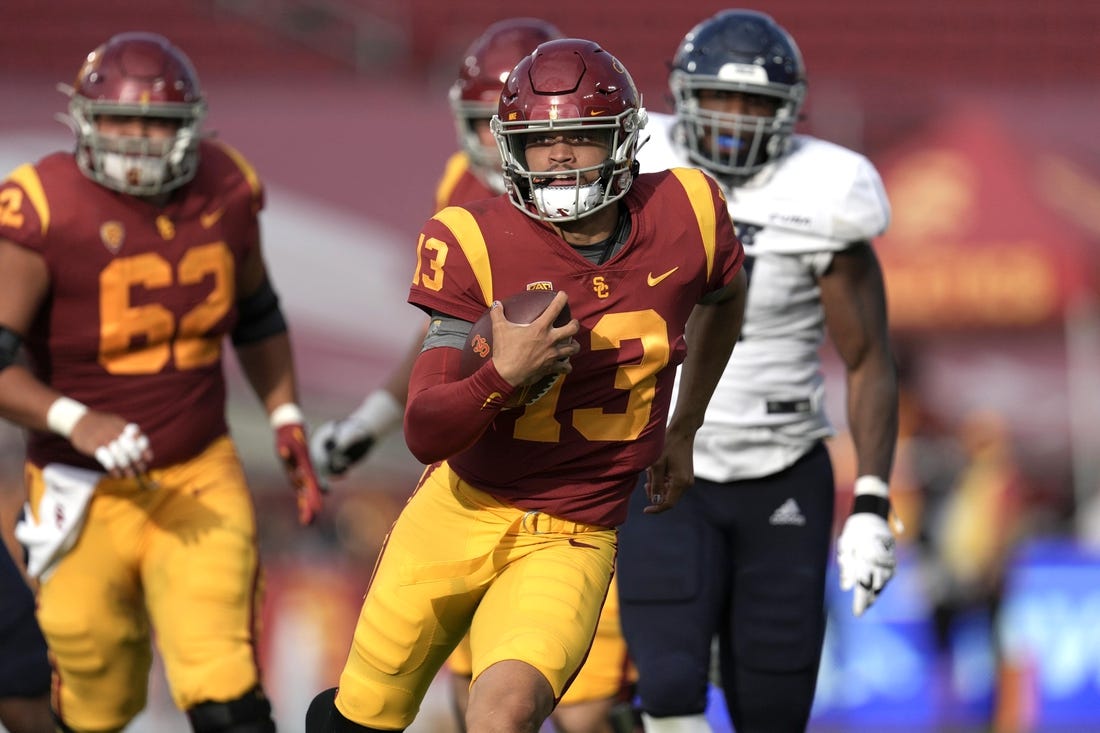 Sep 3, 2022; Los Angeles, California, USA; Southern California Trojans quarterback Caleb Williams (13) carries the ball against the Rice Owls in the second half at United Airlines Field at Los Angeles Memorial Coliseum. Mandatory Credit: Kirby Lee-USA TODAY Sports