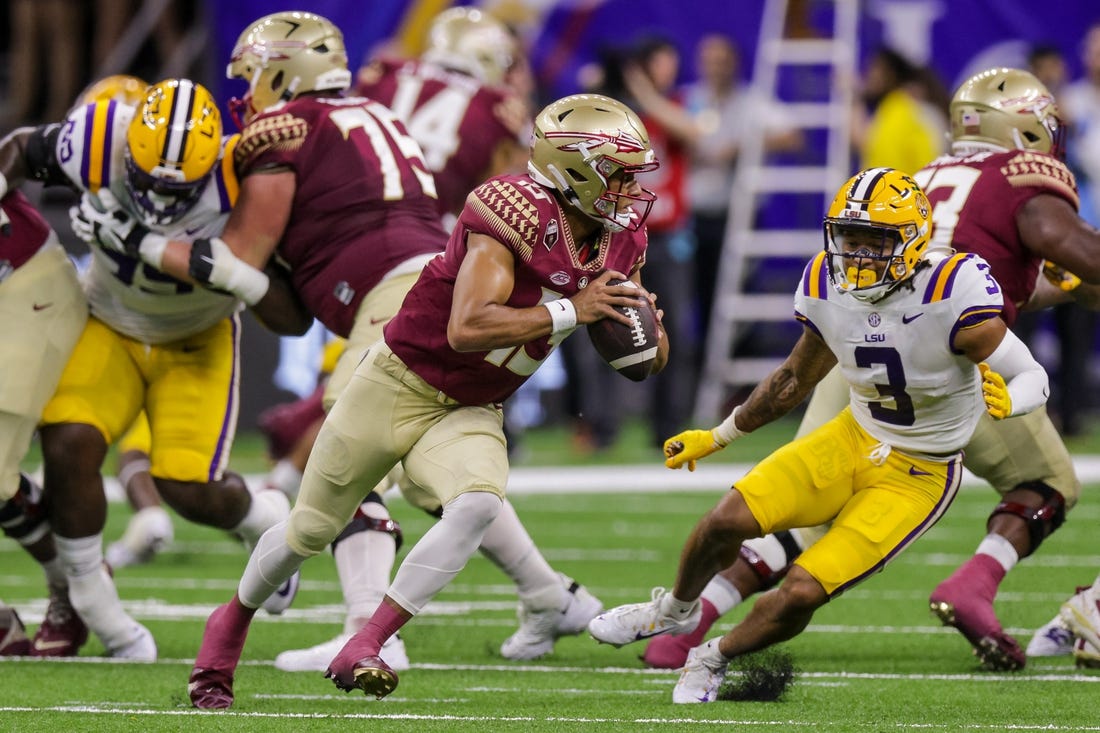 Sep 4, 2022; New Orleans, Louisiana, USA; Florida State Seminoles quarterback Jordan Travis (13) scrambles away from LSU Tigers safety Greg Brooks Jr. (3) during the first half of the game at Caesars Superdome. Mandatory Credit: Stephen Lew-USA TODAY Sports