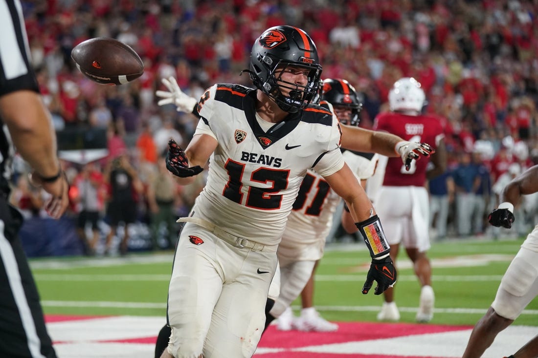 Sep 10, 2022; Fresno, California, USA; Oregon State Beavers running back Jack Colletto (12) flips the ball to an official after scoring a touchdown against the Fresno State Bulldogs on the final play of the game at Valley Children's Stadium. Mandatory Credit: Cary Edmondson-USA TODAY Sports