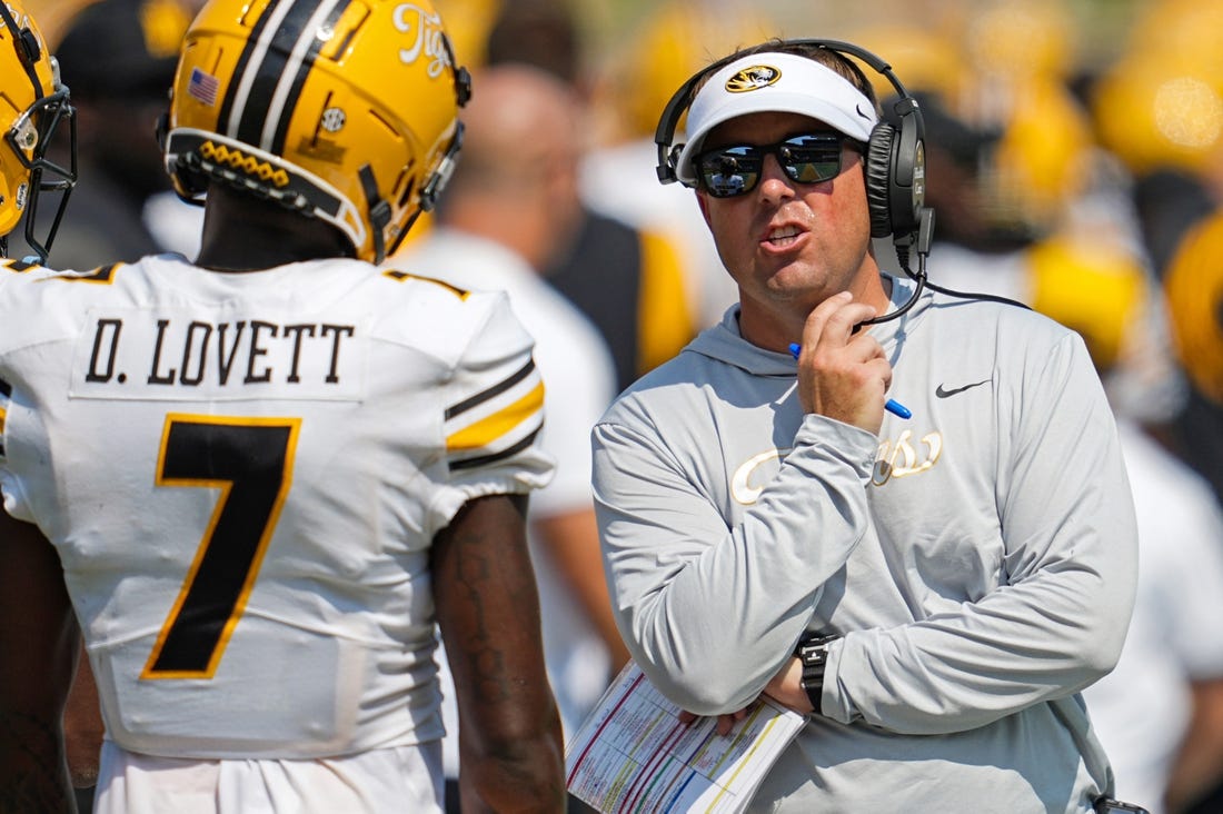 Sep 17, 2022; Columbia, Missouri, USA; Missouri Tigers head coach Eliah Drinkwitz talks with wide receiver Dominic Lovett (7) during the second half against the Abilene Christian Wildcats at Faurot Field at Memorial Stadium. Mandatory Credit: Jay Biggerstaff-USA TODAY Sports