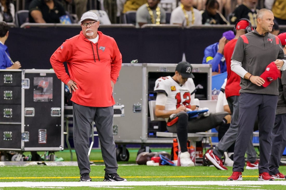Sep 18, 2022; New Orleans, Louisiana, USA; Tampa Bay Buccaneers Senior Football Consultant Bruce Arians reacts to a play as quarterback Tom Brady (12) looks over the play from the bench against the New Orleans Saints during the first half at Caesars Superdome. Mandatory Credit: Stephen Lew-USA TODAY Sports