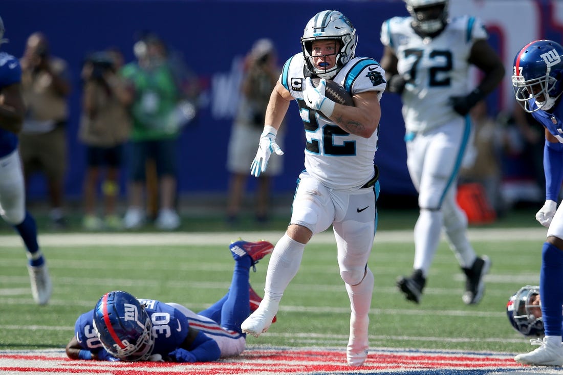 Sep 18, 2022; East Rutherford, New Jersey, USA; Carolina Panthers running back Christian McCaffrey (22) runs with the ball against New York Giants cornerback Darnay Holmes (30) during the fourth quarter at MetLife Stadium. Mandatory Credit: Brad Penner-USA TODAY Sports