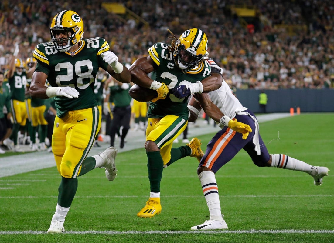 Green Bay Packers running back AJ Dillon (28) blocks for running back Aaron Jones (33) as he scores a touchdown against Chicago Bears safety Jaquan Brisker (9) in the second quarter during their football game Sunday, September 18, 2022, at Lambeau Field in Green Bay, Wis.

Mjs Apc Packvsbears 0918221070djp