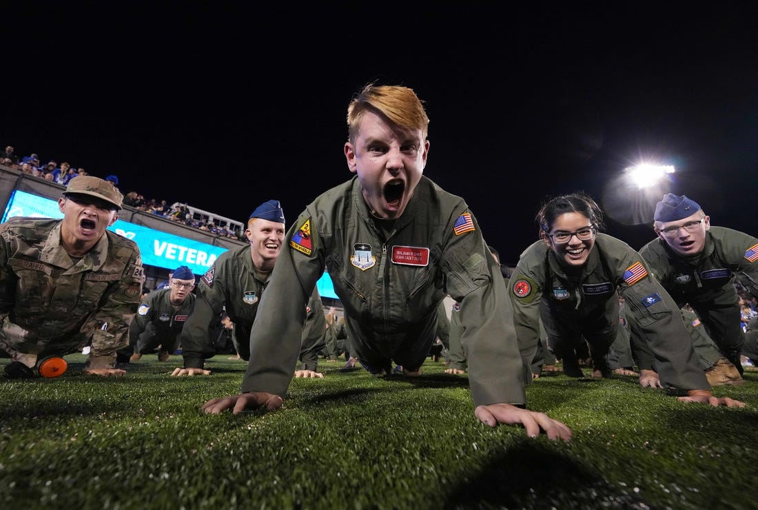Sep 23, 2022; Colorado Springs, Colorado, USA; Air Force cadets finish pushups following a score in the second quarter against the Nevada Wolf Pack at Falcon Stadium. Mandatory Credit: Ron Chenoy-USA TODAY Sports