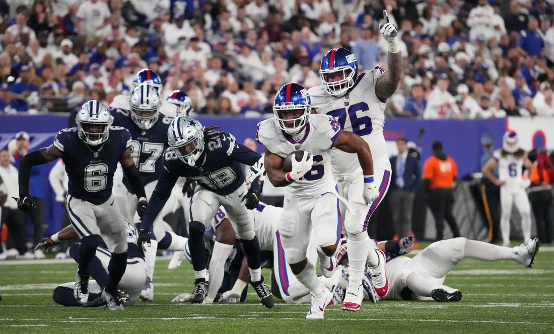 Sep 26, 2022; East Rutherford, NJ, USA;  New York Giants running back Saquon Barkley (26) runs for a touchdown  during the second half against the Dallas Cowboys at MetLife Stadium. Mandatory Credit: Robert Deutsch-USA TODAY Sports