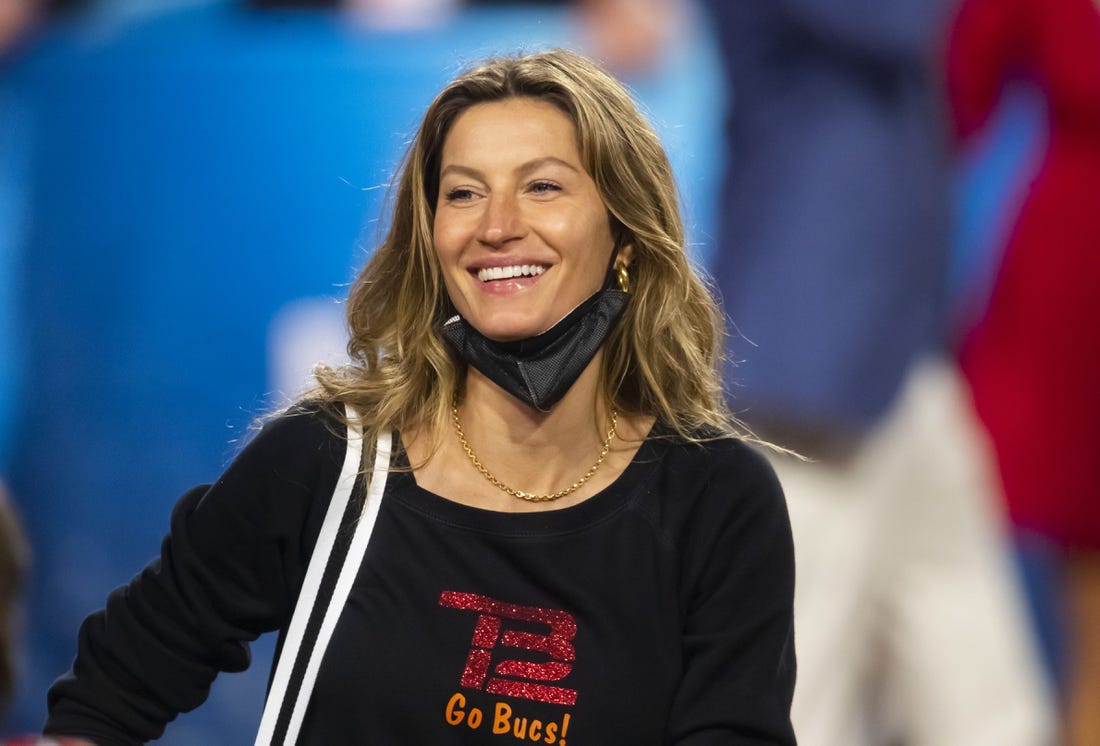 Feb 7, 2021; Tampa, FL, USA;  Gisele Bundchen, wife of Tampa Bay Buccaneers quarterback Tom Brady (not pictured) celebrates after defeating the Kansas City Chiefs in Super Bowl LV at Raymond James Stadium.  Mandatory Credit: Mark J. Rebilas-USA TODAY Sports