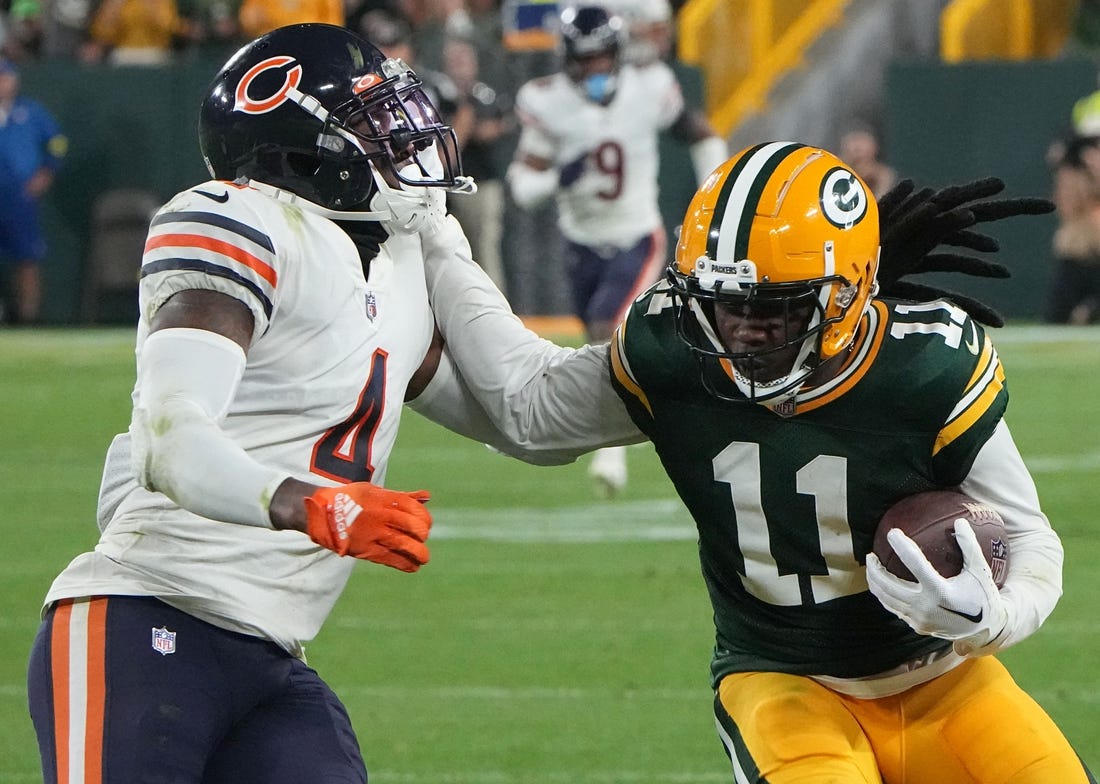 Sep 18, 2022; Green Bay, Wisconsin, USA; Green Bay Packers wide receiver Sammy Watkins (11) stiff arms Chicago Bears safety Eddie Jackson (4) while picking  up 14 yards on a reception during the fourth quarter of their game at Lambeau Field. Mandatory Credit: Mark Hoffman/Milwaukee Journal Sentinel
