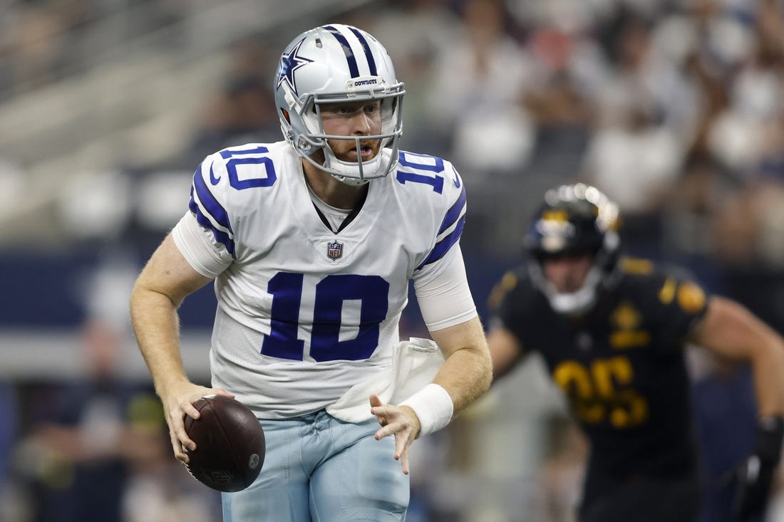 Oct 2, 2022; Arlington, Texas, USA; Dallas Cowboys quarterback Cooper Rush (10) scrambles for a first down in the game against the Washington Commanders at AT&T Stadium. Mandatory Credit: Tim Heitman-USA TODAY Sports