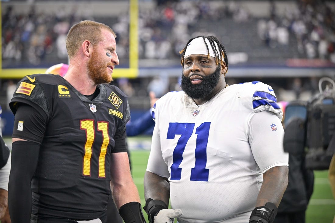 Oct 2, 2022; Arlington, Texas, USA; Washington Commanders quarterback Carson Wentz (11) talks with Dallas Cowboys offensive tackle Jason Peters (71) after the game at AT&T Stadium. Mandatory Credit: Jerome Miron-USA TODAY Sports
