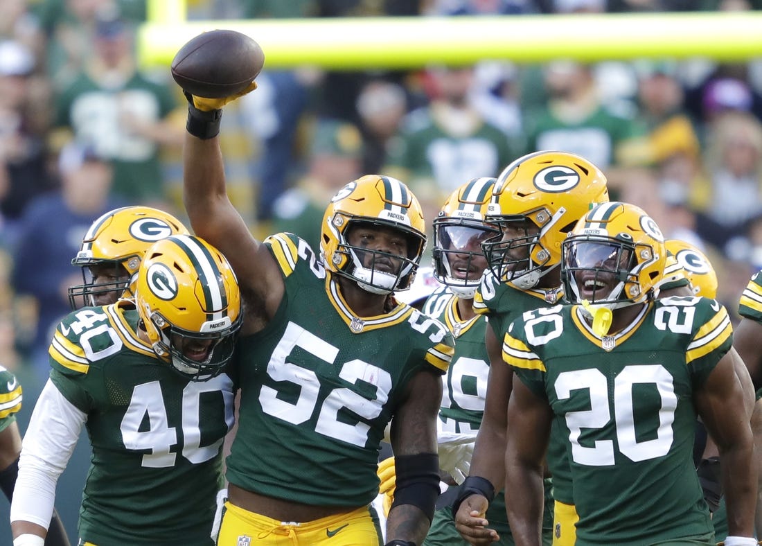Oct 2, 2022; Green Bay, Wisconsin, USA; Green Bay Packers linebacker Rashan Gary (52) celebrates with teammates after sacking New England Patriots quarterback Bailey Zappe (not pictured) during the first half at Lambeau Field. Mandatory Credit: Dan Powers/Appleton Post-Crescent-USA TODAY NETWORK-Wisconsin