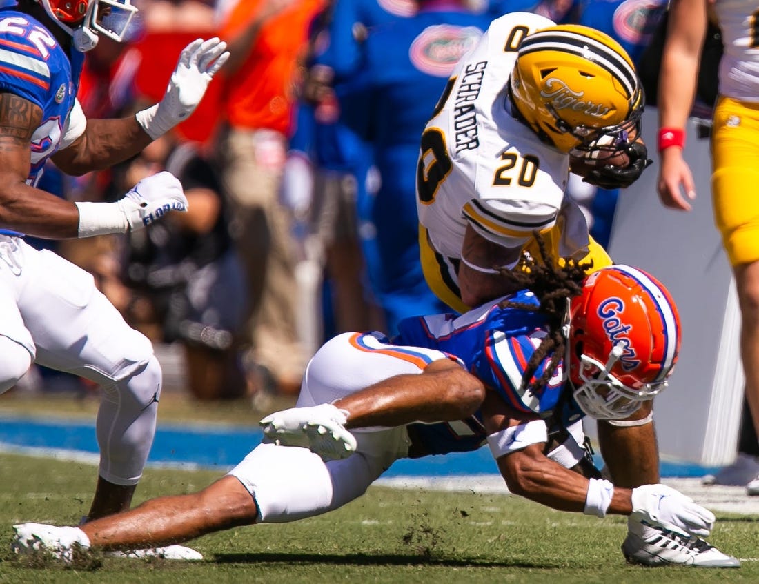 Florida Gators safety Corey Collier Jr. (20) tackles Missouri Tigers running back Cody Schrader (20) in the first half at Steve Spurrier Field at Ben Hill Griffin Stadium in Gainesville, FL on Saturday, October 8, 2022. [Doug Engle/Gainesville Sun]

Ncaa Football Florida Gators Vs Missouri Tigers