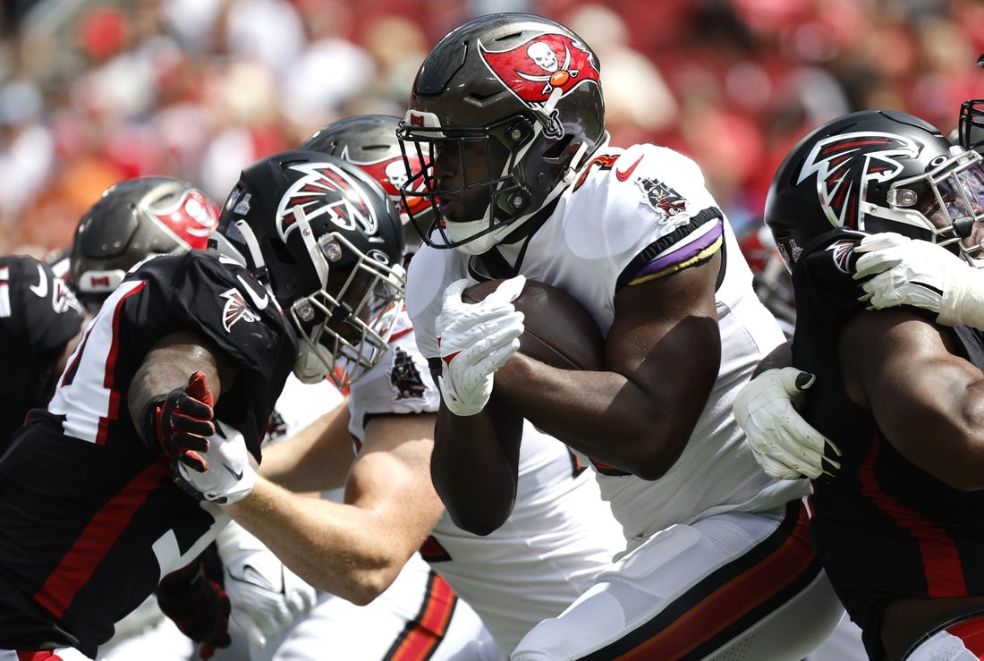 Oct 9, 2022; Tampa, Florida, USA; Tampa Bay Buccaneers running back Leonard Fournette (7) runs with the ball against the Atlanta Falcons during the first quarter at Raymond James Stadium. Mandatory Credit: Kim Klement-USA TODAY Sports