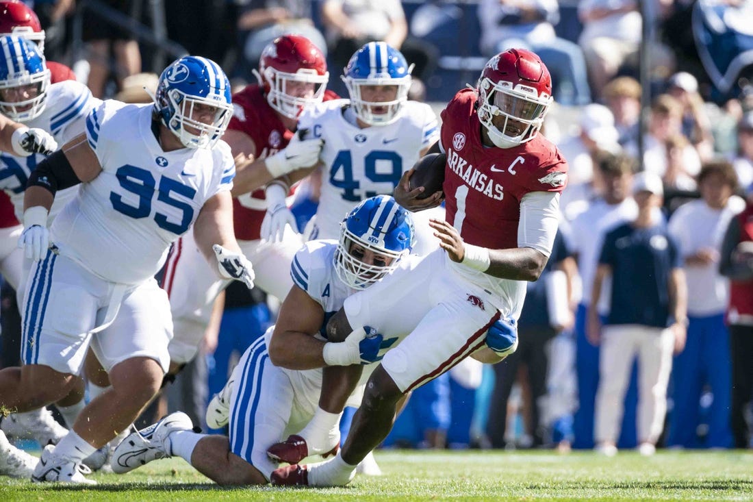 Oct 15, 2022; Provo, Utah, USA; Arkansas Razorbacks quarterback Jakob Robinson (1) is brought down Brigham Young University Cougars defensive lineman Tyler Batty (92) in the first quarter at LaVell Edwards Stadium. Mandatory Credit: Gabriel Mayberry-USA TODAY Sports