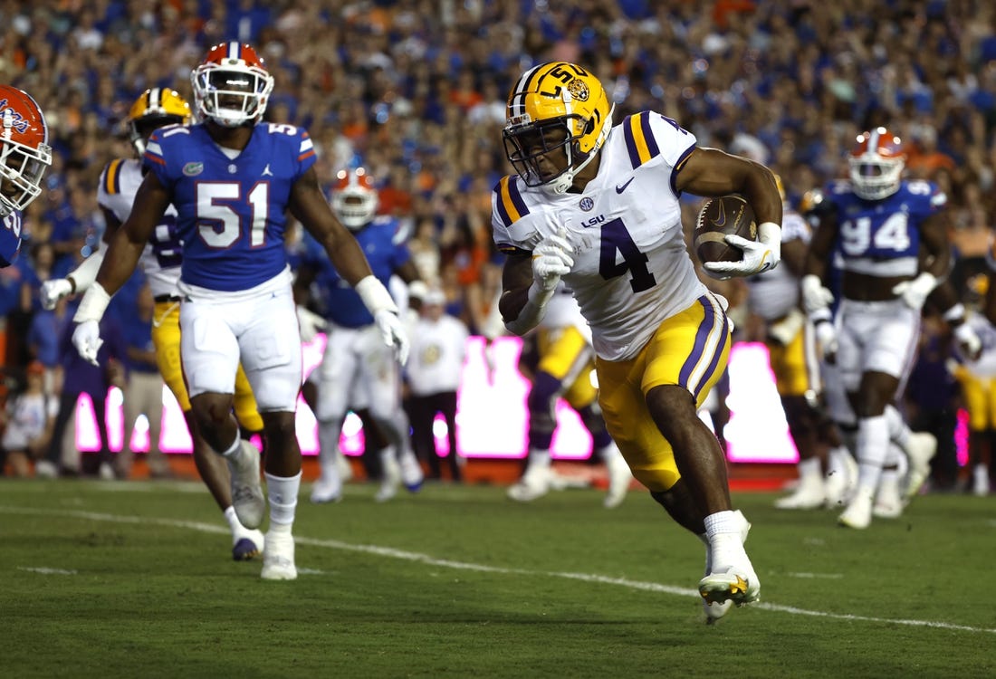 Oct 15, 2022; Gainesville, Florida, USA; LSU Tigers running back John Emery Jr. (4) runs the ball in for a touchdown against the Florida Gators during the first quarter at Ben Hill Griffin Stadium. Mandatory Credit: Kim Klement-USA TODAY Sports