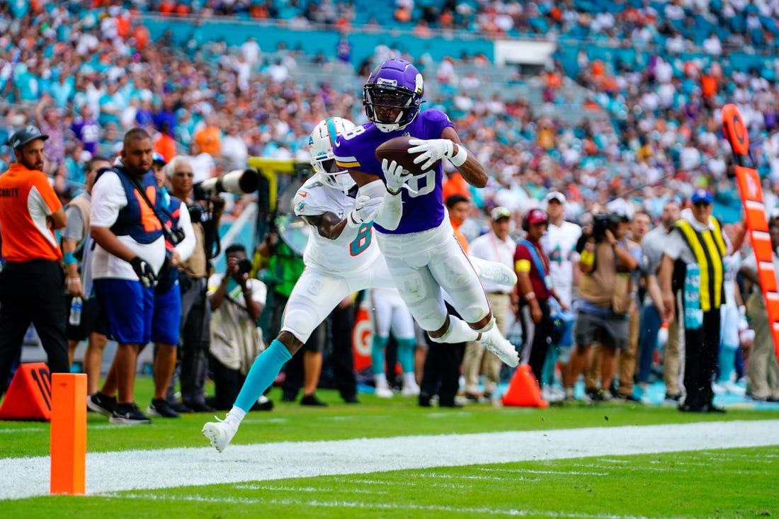 Oct 16, 2022; Miami Gardens, Florida, USA; Miami Dolphins safety Jevon Holland (8) tackles Minnesota Vikings wide receiver Justin Jefferson (18) in to touch during the second quarter at Hard Rock Stadium. Mandatory Credit: Rich Storry-USA TODAY Sports