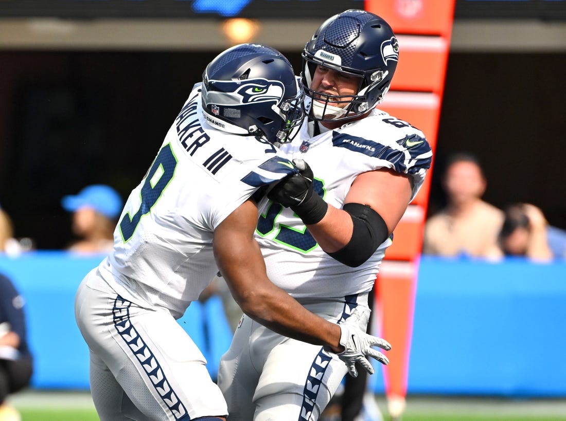 Oct 23, 2022; Inglewood, California, USA;  Seattle Seahawks running back Kenneth Walker III (9) celebrates with Seattle Seahawks guard Austin Blythe (63) after a touchdown in the first half against the Los Angeles Chargers at SoFi Stadium. Mandatory Credit: Jayne Kamin-Oncea-USA TODAY Sports