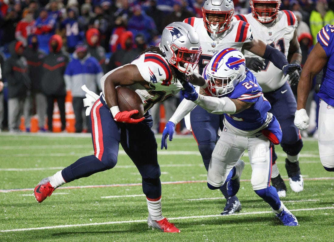 Patriots running back Rhamondre Stevenson is tackled by Bills Jordon Poyer after a short gain.  New England ran the ball 47 times in a 14-10 win.
