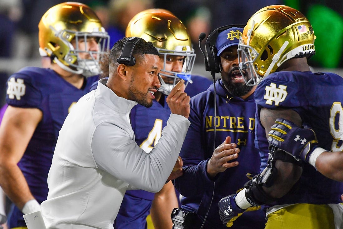 Nov 5, 2022; South Bend, Indiana, USA; Notre Dame Fighting Irish head coach Marcus Freeman talks to defensive lineman Justin Ademilola (9) in the first quarter against the Clemson Tigers at Notre Dame Stadium. Mandatory Credit: Matt Cashore-USA TODAY Sports
