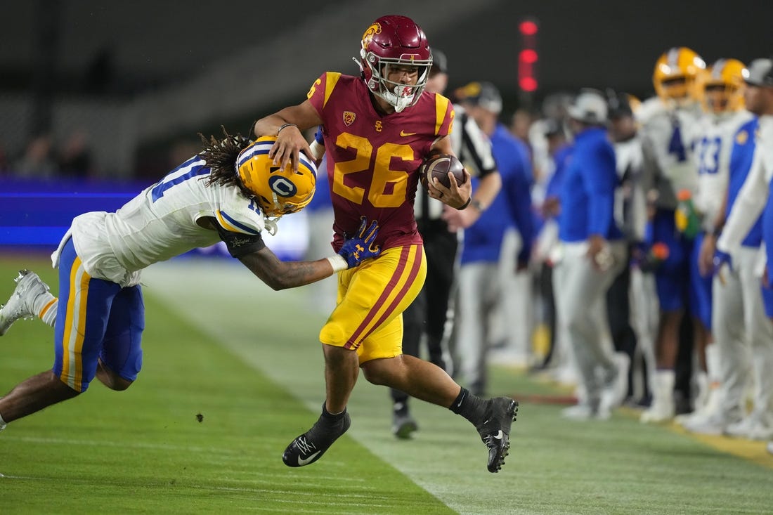Nov 5, 2022; Los Angeles, California, USA; Southern California Trojans running back Travis Dye (26) is knocked out of bounds by California Golden Bears cornerback Tyson McWilliams (11) in the second half at United Airlines Field at Los Angeles Memorial Coliseum. Mandatory Credit: Kirby Lee-USA TODAY Sports