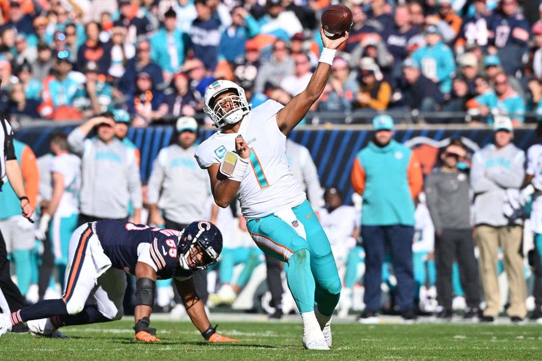 Nov 6, 2022; Chicago, Illinois, USA;  Miami Dolphins quarterback Tua Tagovailoa (1) makes a pass after avoiding a sack in the second quarter against the Chicago Bears at Soldier Field. Mandatory Credit: Jamie Sabau-USA TODAY Sports
