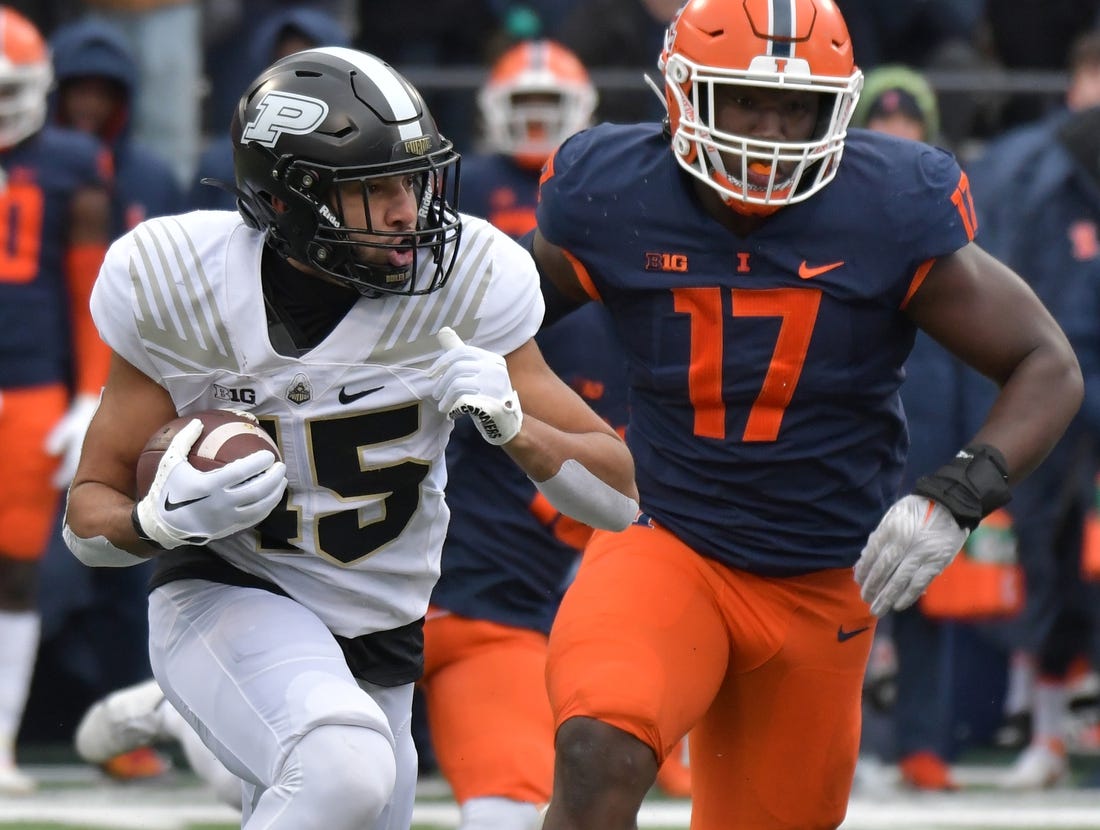 Nov 12, 2022; Champaign, Illinois, USA;  Purdue Boilermakers running back Devin Mockobee (45) runs with the ball as Illinois Fighting Illini linebacker Gabe Jacas (17) pursues during the first half at Memorial Stadium. Mandatory Credit: Ron Johnson-USA TODAY Sports