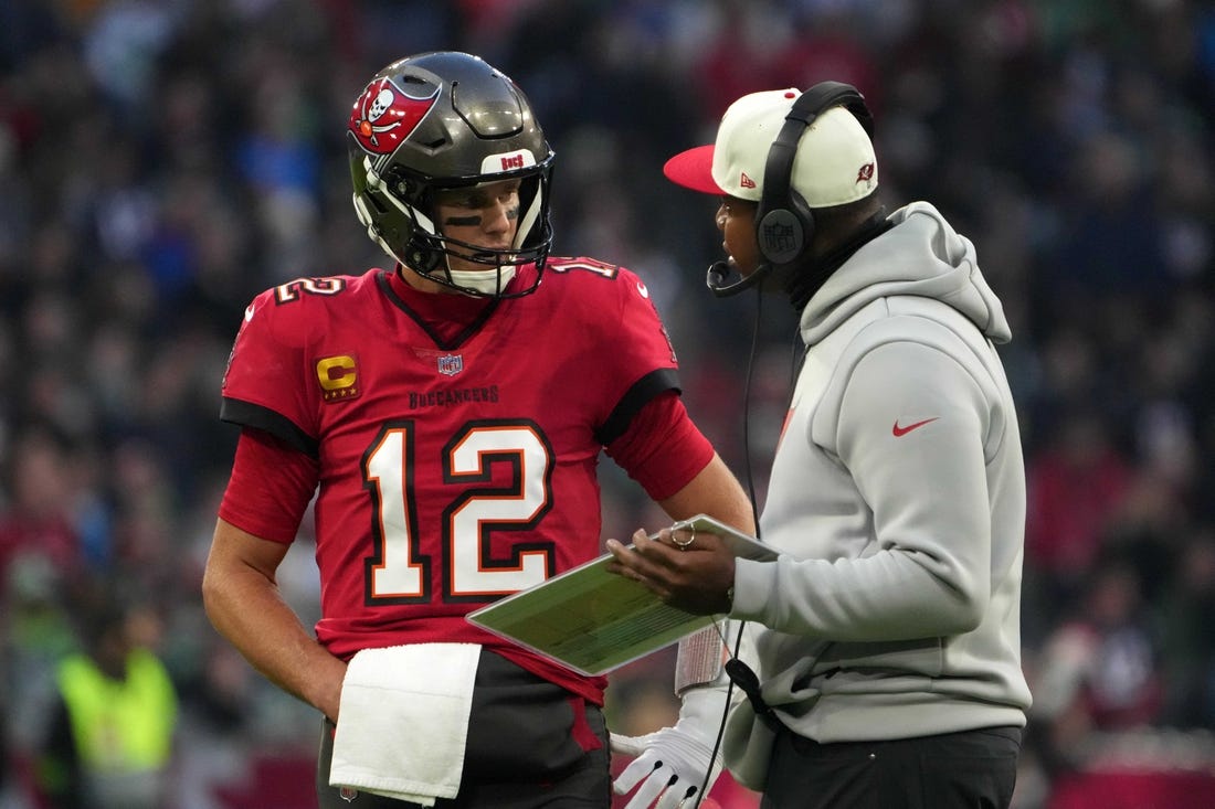 Nov 13, 2022; Munich, Germany; Tampa Bay Buccaneers quarterback Tom Brady (12) talks with offensive coordinator Byron Leftwich in the first half against the Seattle Seahawks during an NFL International Series game at Allianz Arena. Mandatory Credit: Kirby Lee-USA TODAY Sports