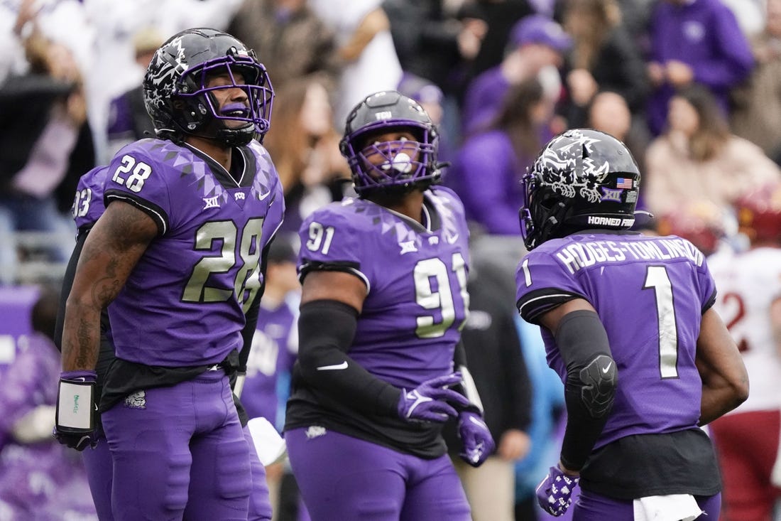 Nov 26, 2022; Fort Worth, Texas, USA; ]TCU Horned Frogs safety Millard Bradford (28) celebrates his 36-yard interception returned for a touchdown against the Iowa State Cyclones during the first half at Amon G. Carter Stadium. Mandatory Credit: Raymond Carlin III-USA TODAY Sports