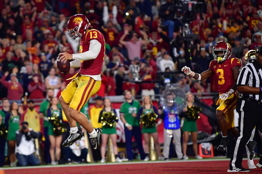 Nov 26, 2022; Los Angeles, California, USA; Southern California Trojans quarterback Caleb Williams (13) scores a touchdown against the Notre Dame Fighting Irish during the first half at the Los Angeles Memorial Coliseum. Mandatory Credit: Gary A. Vasquez-USA TODAY Sports