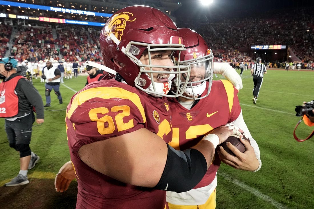 Nov 26, 2022; Los Angeles, California, USA; Southern California Trojans quarterback Caleb Williams (13) and offensive lineman Brett Neilon (62) celebrate after the game against the Notre Dame Fighting Irish at United Airlines Field at Los Angeles Memorial Coliseum. Mandatory Credit: Kirby Lee-USA TODAY Sports