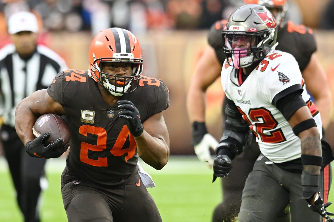 Nov 27, 2022; Cleveland, Ohio, USA; Cleveland Browns running back Nick Chubb (24) runs with the ball as Tampa Bay Buccaneers safety Mike Edwards (32) defends during the first half at FirstEnergy Stadium. Mandatory Credit: Ken Blaze-USA TODAY Sports