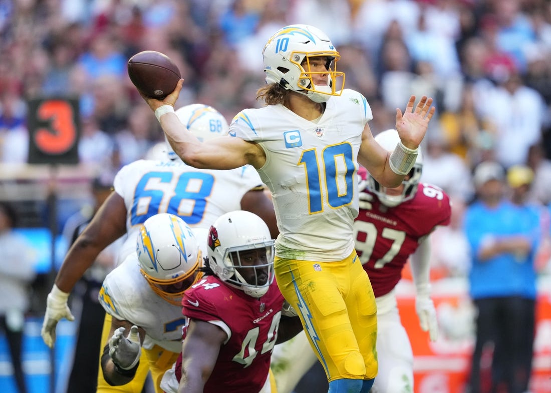Nov 27, 2022; Glendale, AZ, USA; Los Angeles Chargers quarterback Justin Herbert (10) throws a pass against the Arizona Cardinals in the second half at State Farm Stadium. Mandatory Credit: Joe Camporeale-USA TODAY Sports