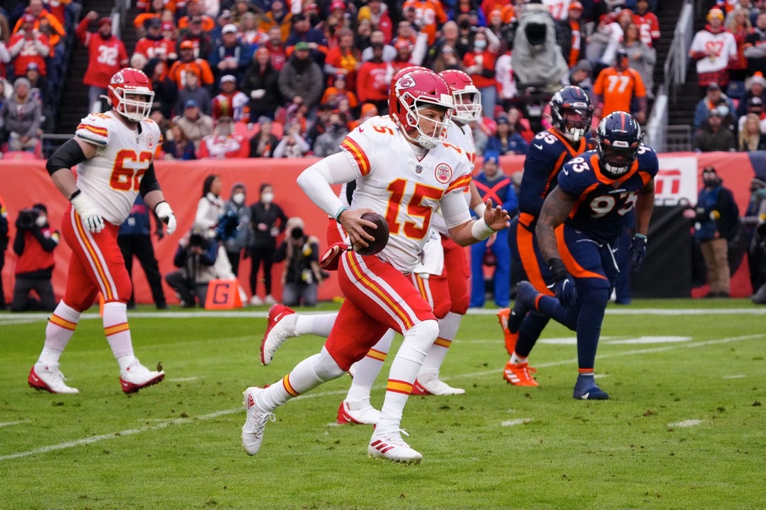 Jan 8, 2022; Denver, Colorado, USA; Kansas City Chiefs quarterback Patrick Mahomes (15) runs the ball in the first quarter against the Denver Broncos at Empower Field at Mile High. Mandatory Credit: Ron Chenoy-USA TODAY Sports