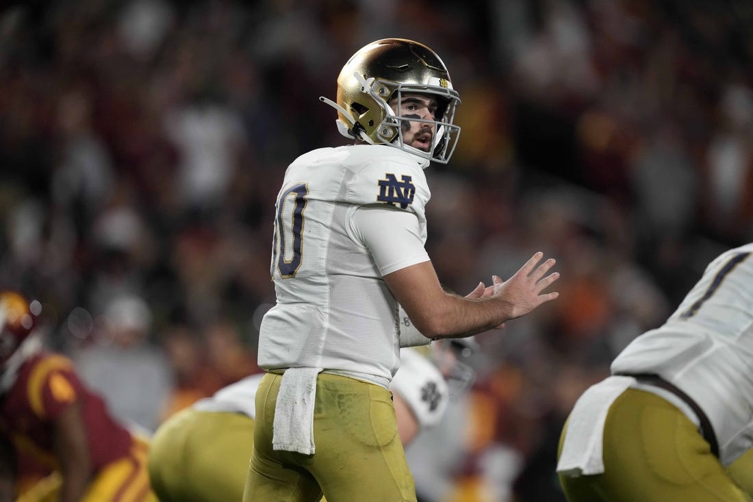 Nov 26, 2022; Los Angeles, California, USA; Notre Dame Fighting Irish quarterback Drew Pyne (10) prepares to take the snap against the Southern California Trojans in the first half at United Airlines Field at Los Angeles Memorial Coliseum. Mandatory Credit: Kirby Lee-USA TODAY Sports