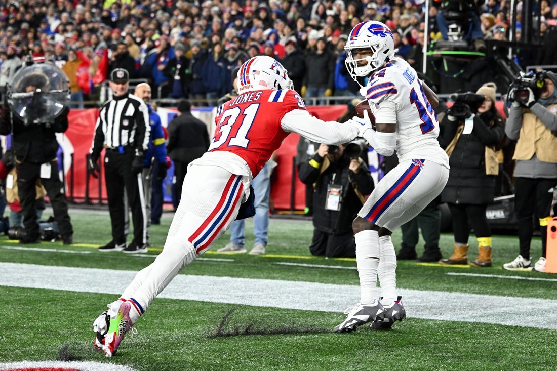 Dec 1, 2022; Foxborough, Massachusetts, USA; Buffalo Bills wide receiver Stefon Diggs (14) makes a catch for a touchdown in front of New England Patriots cornerback Jonathan Jones (31) during the first half at Gillette Stadium. Mandatory Credit: Brian Fluharty-USA TODAY Sports