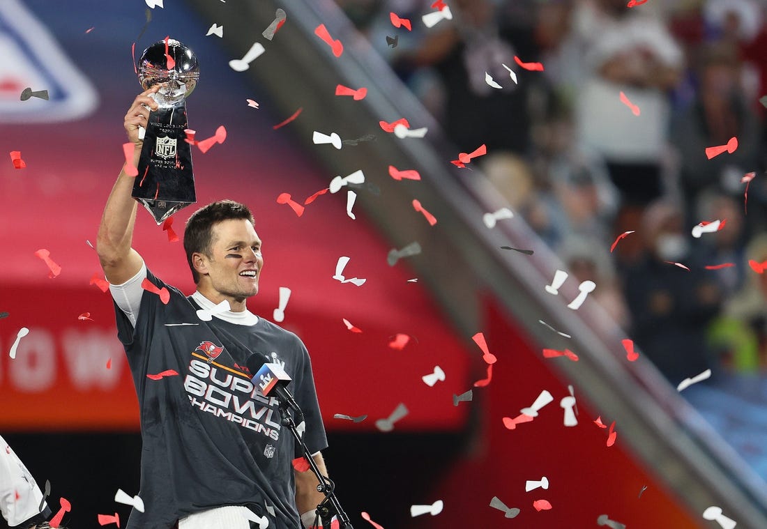 Feb 7, 2021; Tampa, FL, USA; Tampa Bay Buccaneers quarterback Tom Brady (12) hoists the Vince Lombardi Trophy after defeating the Kansas City Chiefs in Super Bowl LV at Raymond James Stadium. Mandatory Credit: Matthew Emmons-USA TODAY Sports
