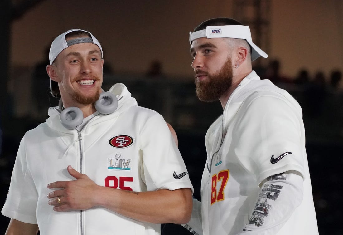 San Francisco 49ers tight end George Kittle (85) greets Kansas City Chiefs tight end Travis Kelce (87) during Super Bowl LIV Opening Night at Marlins Park.  Mandatory Credit: Kirby Lee-USA TODAY Sports
