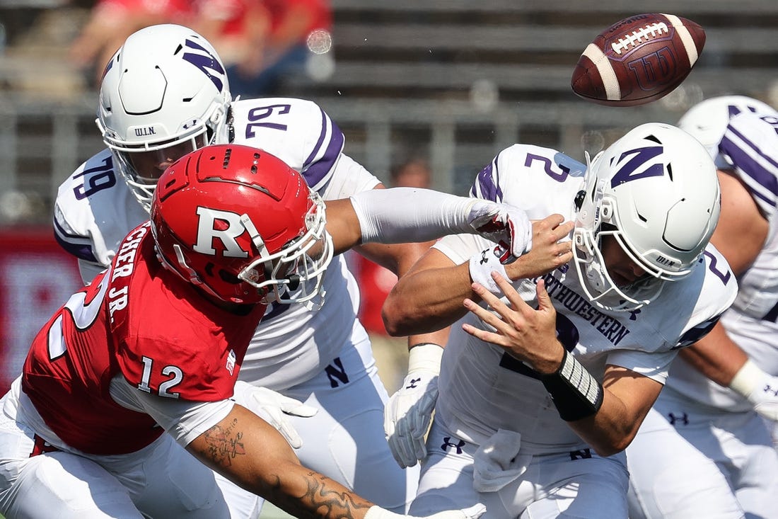Sep 3, 2023; Piscataway, New Jersey, USA; Rutgers Scarlet Knights defensive lineman Kenny Fletcher (12) forces a fumble by Northwestern Wildcats quarterback Ben Bryant (2) during the second half at SHI Stadium. Mandatory Credit: Vincent Carchietta-USA TODAY Sports