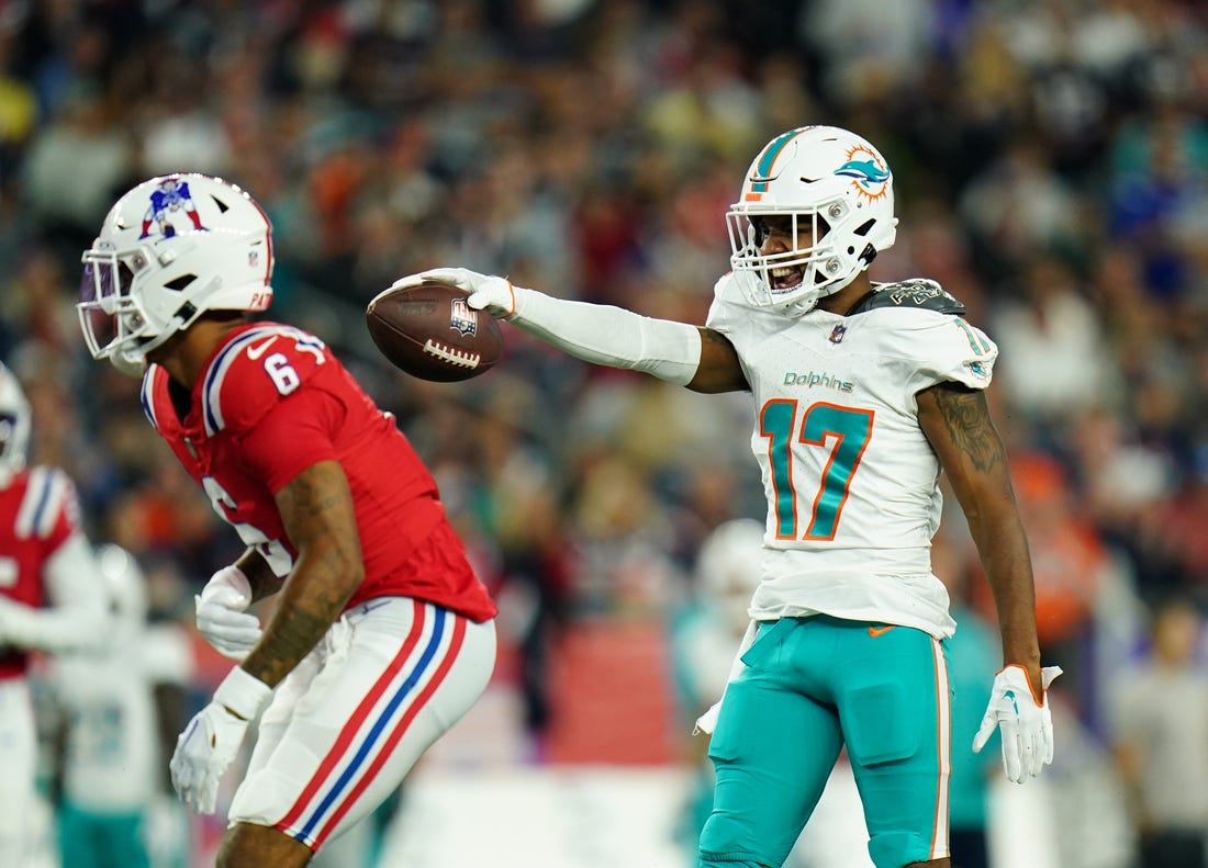 Sep 17, 2023; Foxborough, Massachusetts, USA; Miami Dolphins wide receiver Jaylen Waddle (17) reacts after his first down catch against New England Patriots cornerback Christian Gonzalez (6) in the second quarter at Gillette Stadium. Mandatory Credit: David Butler II-USA TODAY Sports