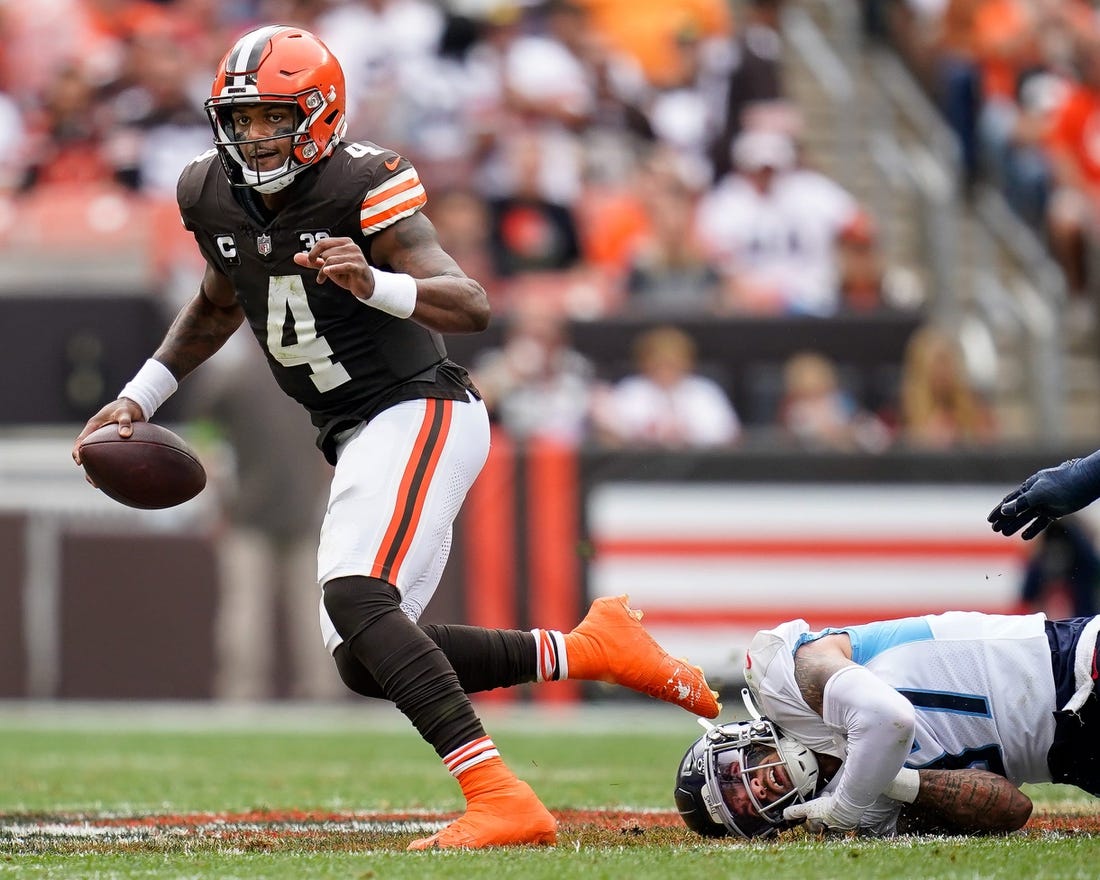 Cleveland Browns quarterback Deshaun Watson (4) escapes from Tennessee Titans safety Amani Hooker (37) during the second quarter in Cleveland, Ohio, Sunday, Sept. 24, 2023.