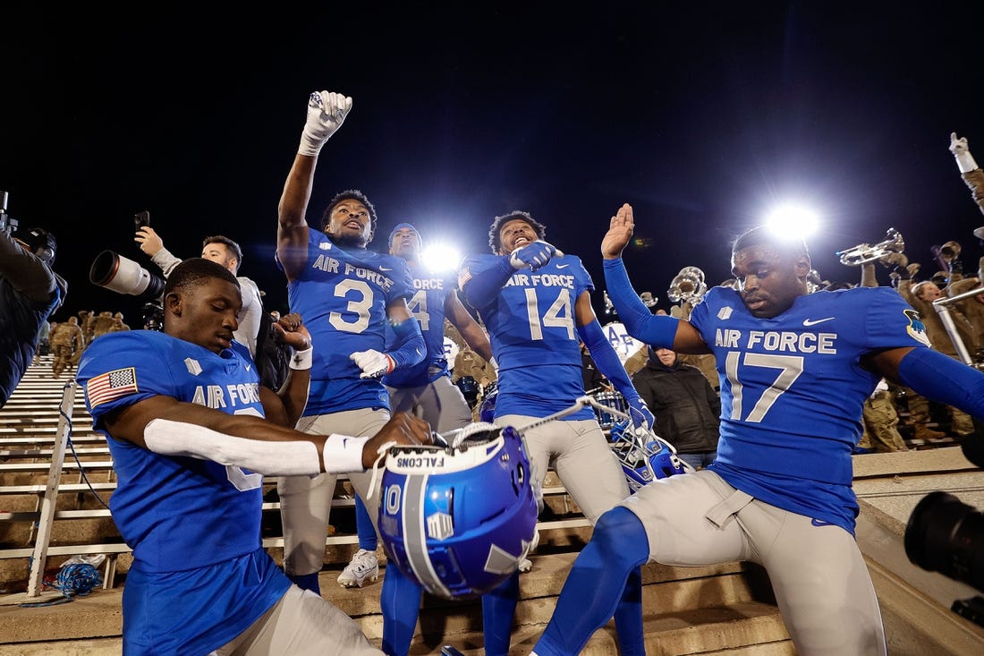 Oct 14, 2023; Colorado Springs, Colorado, USA; Air Force Falcons defensive back Trey Williams (0) and defensive back Jamari Bellamy (3) and fullback Emmanuel Michel (4) and defensive back K.C. Beard (14) and cornerback Zion Kelly (17) celebrate after the game against the Wyoming Cowboys at Falcon Stadium. Mandatory Credit: Isaiah J. Downing-USA TODAY Sports