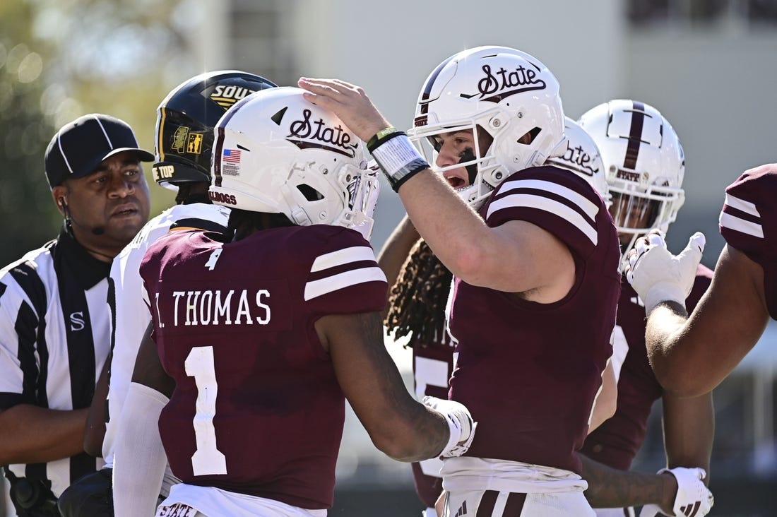 Nov 18, 2023; Starkville, Mississippi, USA; Mississippi State Bulldogs quarterback Will Rogers (2) reacts with  wide receiver Zavion Thomas (1) after a touchdown against the Southern Miss Golden Eagles at Davis Wade Stadium at Scott Field. Mandatory Credit: Matt Bush-USA TODAY Sports