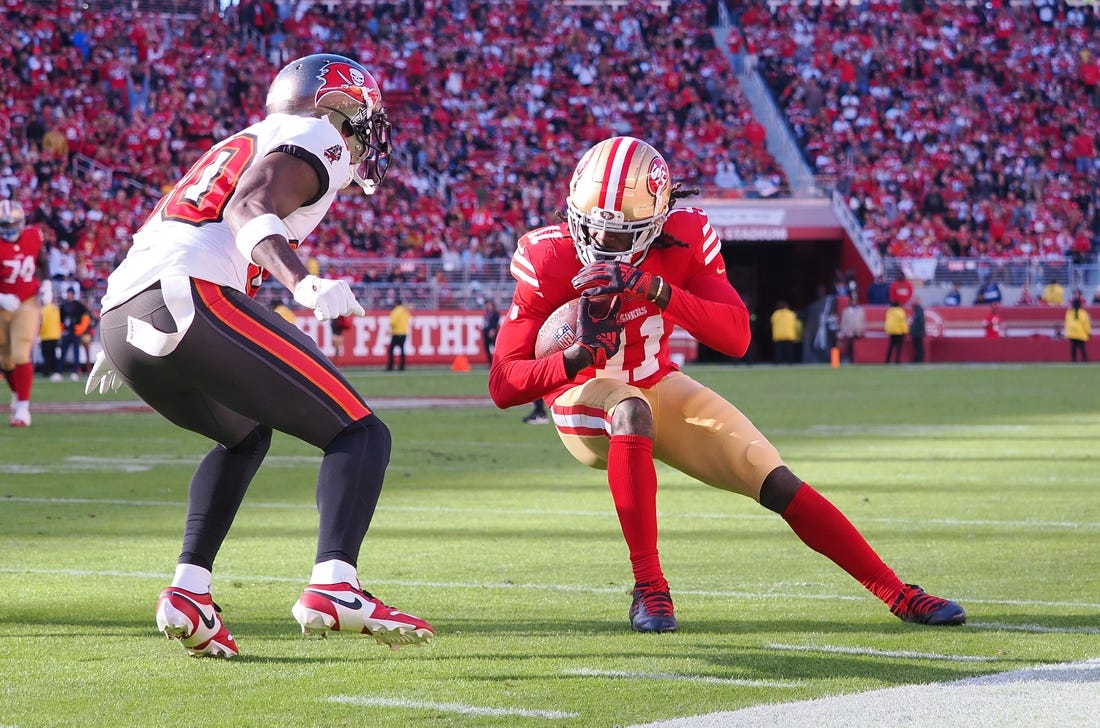 Nov 19, 2023; Santa Clara, California, USA; San Francisco 49ers wide receiver Brandon Aiyuk (11) leans into the play against Tampa Bay Buccaneers defensive back Dee Delaney (30) during the second quarter at Levi's Stadium. Mandatory Credit: Kelley L Cox-USA TODAY Sports