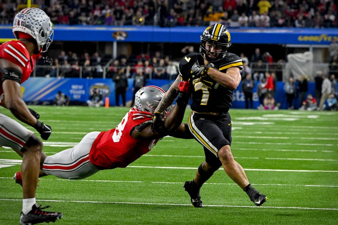 Dec 29, 2023; Arlington, TX, USA; Missouri Tigers running back Cody Schrader (7) runs for a first down against the Ohio State Buckeyes during the fourth quarter at AT&T Stadium. Mandatory Credit: Jerome Miron-USA TODAY Sports