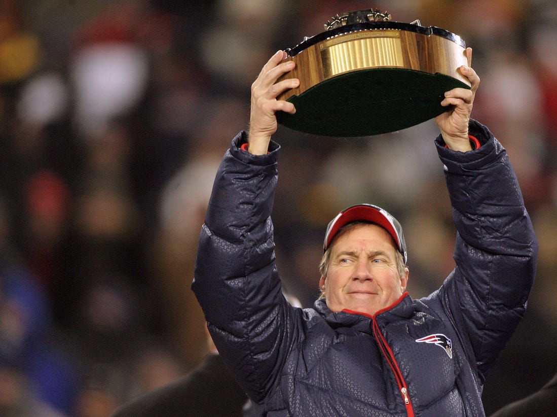 2008: Head Coach Bill Belichick raises the Lamar Hunt trophy after the Patriots won 21-12 over the Chargers for the AFC Championship and advance to Super Bowl XLII.
