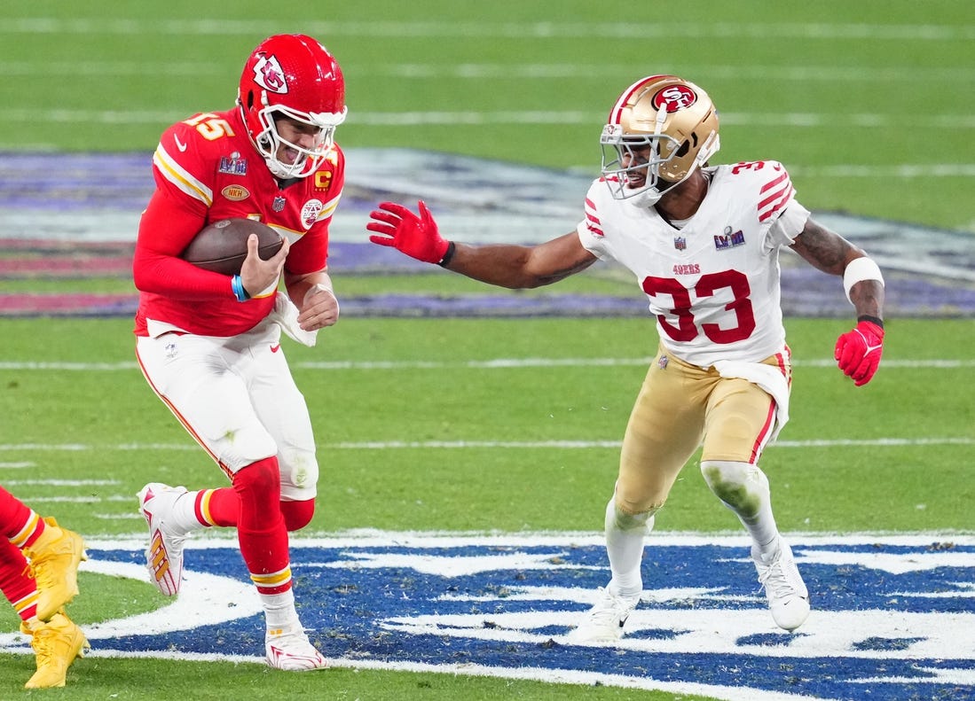 Feb 11, 2024; Paradise, Nevada, USA; Kansas City Chiefs quarterback Patrick Mahomes (15) is chased by San Francisco 49ers safety Logan Ryan (33) in the second half in Super Bowl LVIII at Allegiant Stadium. Mandatory Credit: Stephen R. Sylvanie-USA TODAY Sports